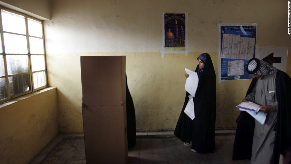 Iraqis look over their ballots on election day in the Sadr City neighborhood of Baghdad on January 30, 2005. It was the country&#39;s first multiparty election in half a century.