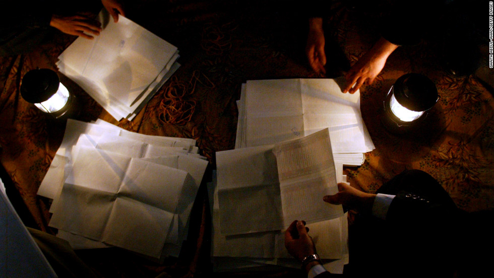 Election officials count ballot papers at night on January 30, 2005, in the Shiite holy city of Najaf. Despite threats, thousands of men and women cast their votes.