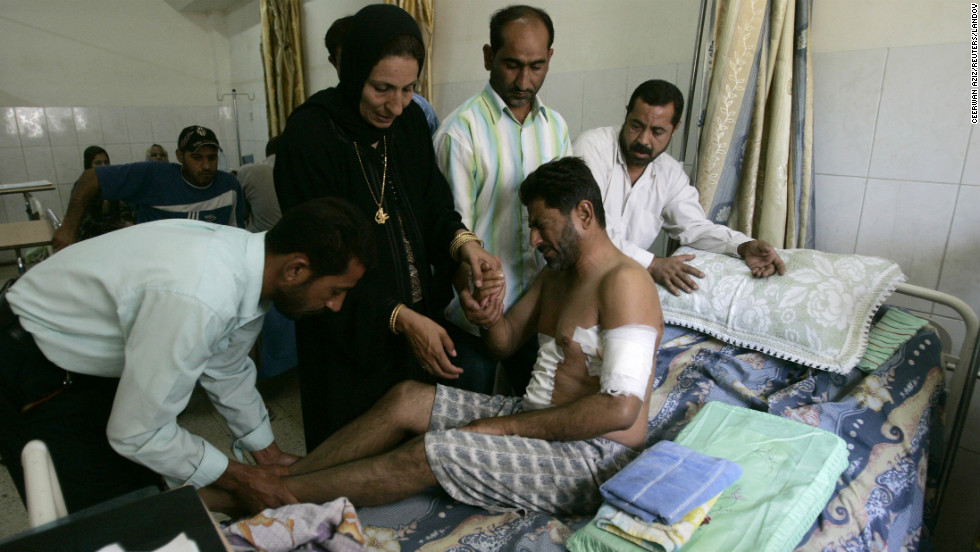 Relatives help an Iraqi man at a hospital in Baghdad on September 20, 2007. He was injured when Blackwater security contractors opened fire on civilians on September 16, killing 17. The company lost its contract to guard U.S. staff in Iraq after the country&#39;s government refused to renew its operating license.
