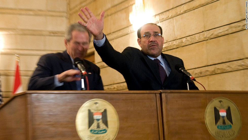 Iraqi Prime Minister Nuri al-Maliki tries to block a shoe thrown at President Bush during a news conference in Baghdad on December 14, 2008. The Iraqi journalist who threw the shoes missed the president but could be heard yelling in Arabic, &quot;This is a farewell ... you dog!&quot;