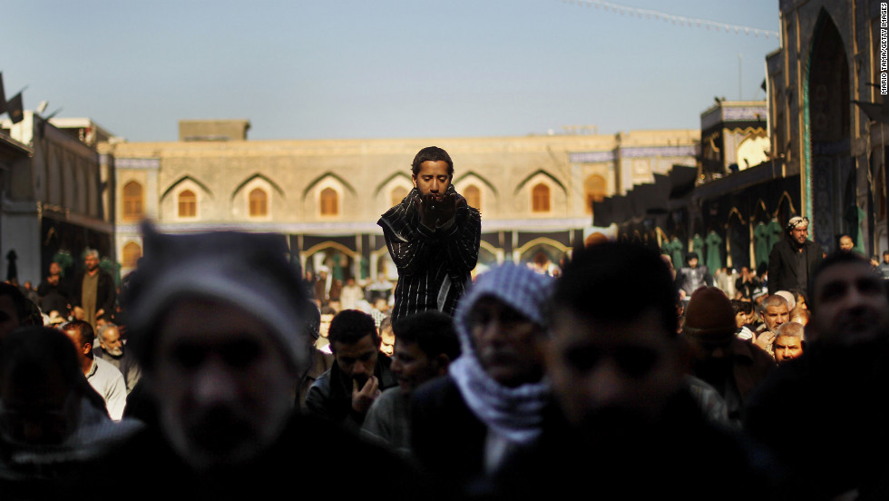 Shiite worshipers pray during an Ashura commemoration ceremony at the Kadhimiya shrine in Baghdad on December 6, 2011. Ashura marks the death of Prophet Mohammed&#39;s grandson, the revered Imam Hussein.