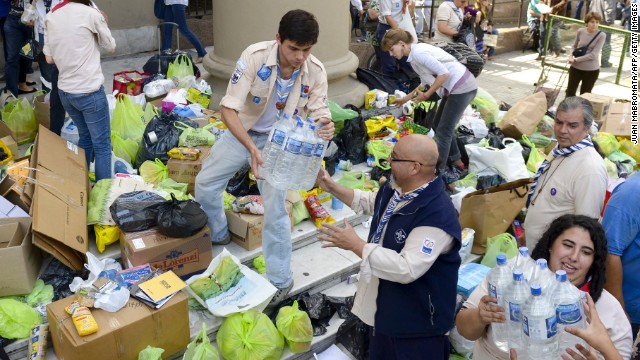 Volunteers load a truck with donated supplies in front of the Metropolitan Cathedral in Buenos Aires on Thursday, April 4. Rescuers were still searching for people missing in nearby La Plata after the storm.