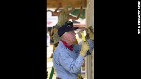 LAGRANGE, GA - JUNE 10: Former U.S. President Jimmy Carter attaches siding to the front of a Habitat for Humanity home being built June 10, 2003 in LaGrange, Georgia. More than 90 homes are being built in LaGrange; Valdosta, Georgia; and Anniston, Alabama by volunteers as part of Habitat for Humanity International&#39;s Jimmy Carter Work Project 2003. (Photo by Erik S. Lesser/Getty Images)