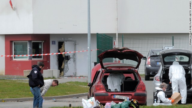   Forensic experts work near a door destroyed by the explosives of Faid in 2013. 