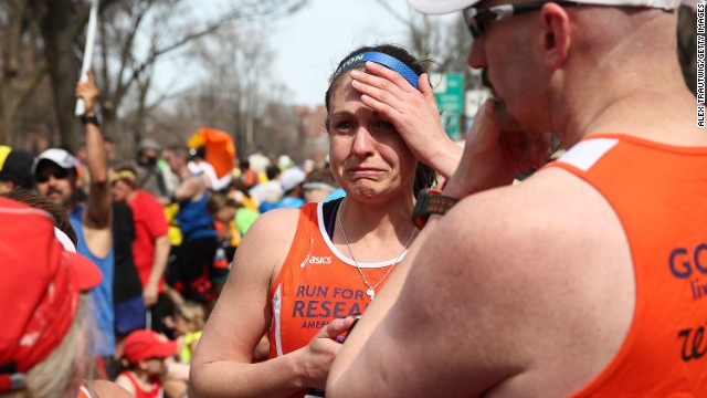 BOSTON, MA - APRIL 15:  A runner reacts near Kenmore Square after two bombs exploded during the 117th Boston Marathon on April 15, 2013 in Boston, Massachusetts. Two people are confirmed dead and at least 23 injured after two explosions went off near the finish line to the marathon.  (Photo by Alex Trautwig/Getty Images)