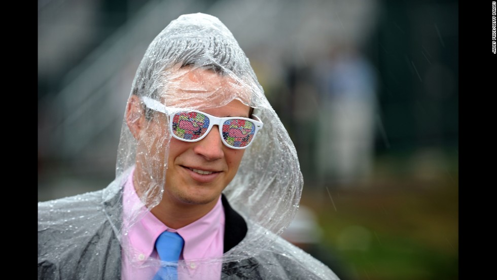 A race fan dons a plastic poncho to ward off the rain.