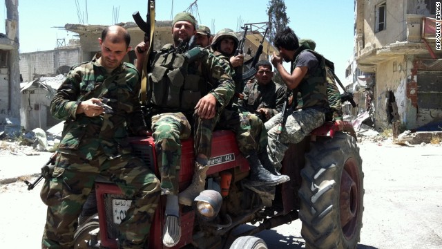 Syrian army's soldiers sit on a tractor holding their weapons on June 5, 2013 in the city of Qusayr in Syria's central Homs province, after the Syrian government forces seized total control of the city and the surrounding region.