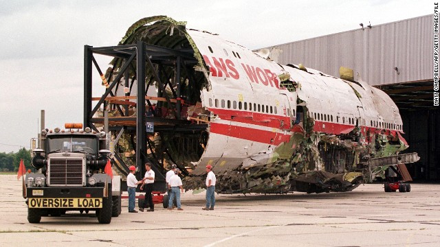 The partially reconstructed fuselage of TWA Flight 800 is pulled out of a hangar in Calverton, New York on September 14, 1999.