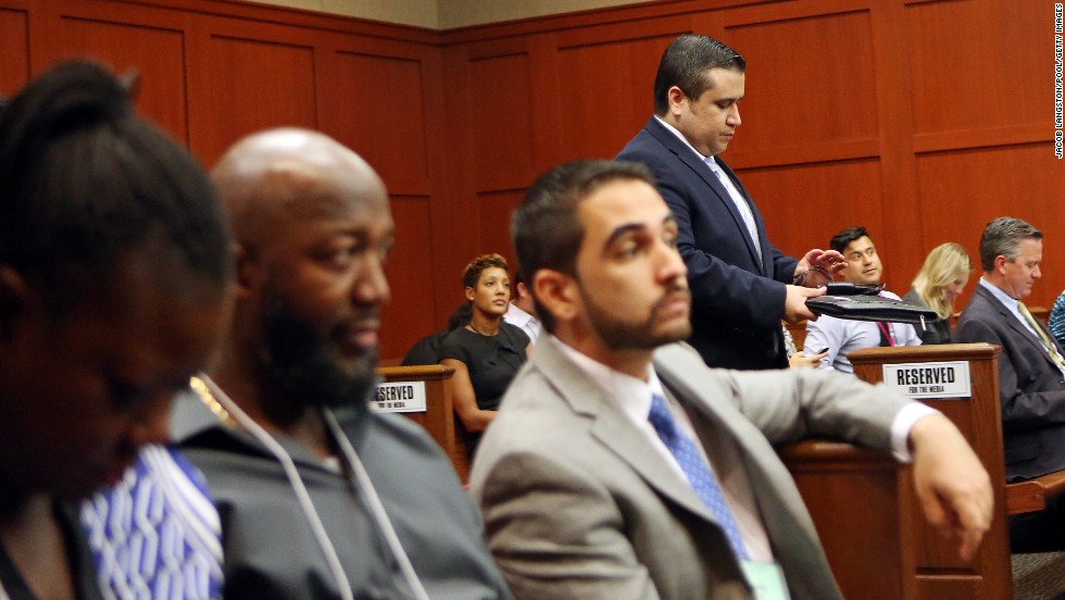 Zimmerman walks past Martin&#39;s parents, Sybrina Fulton, left, and Tracy Martin, second from left, as he enters the courtroom after lunch recess on June 26.