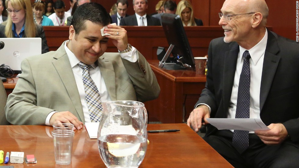 Zimmerman laughs with defense attorney Don West during his trial on June 25.