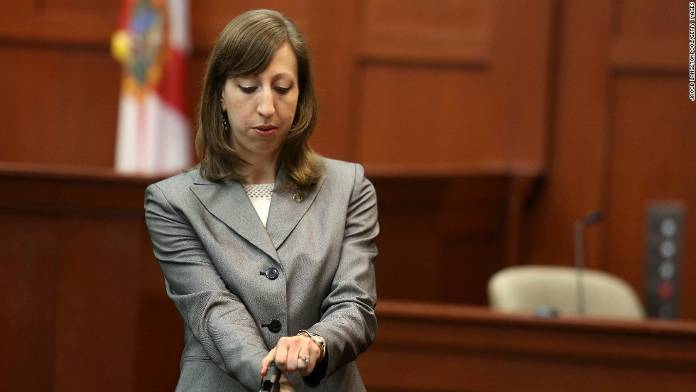 Firearms analyst Amy Siewert from the Florida Department of Law Enforcement answers questions from the prosecution while holding Zimmerman&#39;s gun on July 3. Siewert examined the gun and said Zimmerman had one bullet ready to fire in the chamber as well as a fully loaded magazine when the shooting occurred. 