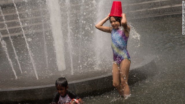 Young children cool off in a fountain in New York's Washington Square Park on Monday.