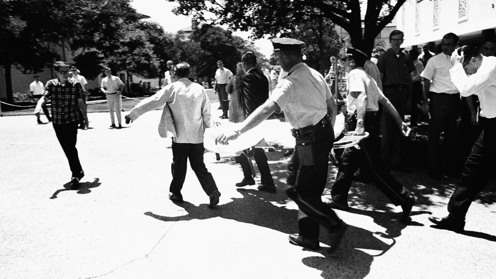 Officers in Austin, Texas, carry victims across the University of Texas campus after Charles Joseph Whitman opened fire from the school&#39;s tower, killing 16 people and wounding 30 in 1966. Police officers shot and killed Whitman, who had killed his mother and wife earlier in the day. 