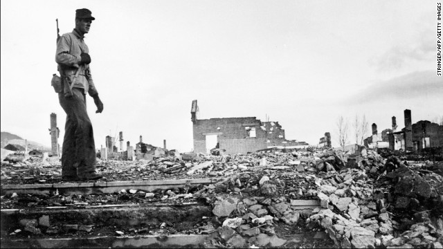 An American soldier walks around the rubble of Hamhung, Korea, circa 1950.