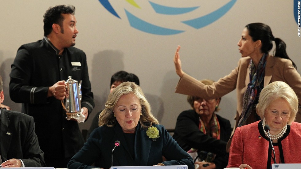 Abedin asks a coffee server to move out of the way as Clinton speaks during a roundtable discussion at the APEC Women and the Economy Summit on September 16, 2011, in San Francisco.