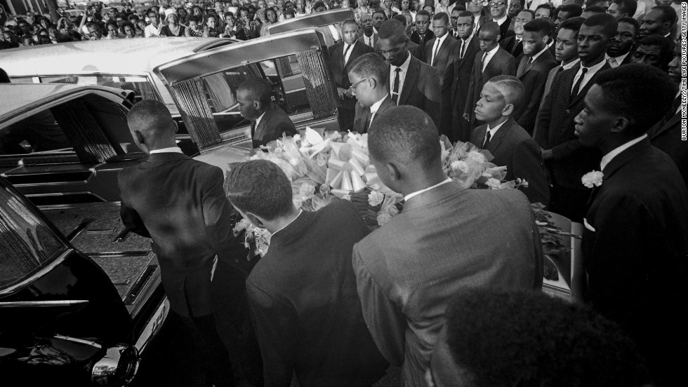 A coffin is loaded into a hearse at a funeral for the girls. An estimated 8,000 people attended the service.