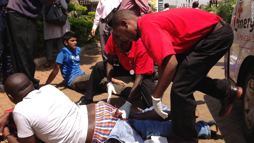 Paramedics treat an injured man outside the mall. 