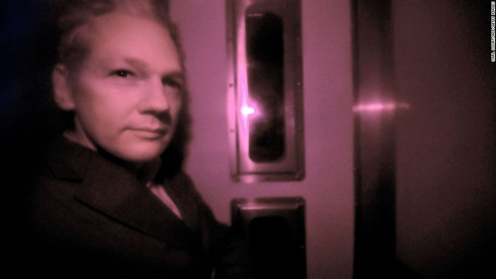 Assange sits behind the tinted window of a police vehicle in London on December 14, 2010. Assange had turned himself in to London authorities on December 7 and was released on bail and put on house arrest on December 16. In February 2011, a judge ruled in support of Assange&#39;s extradition to Sweden. Assange&#39;s lawyers filed an appeal.