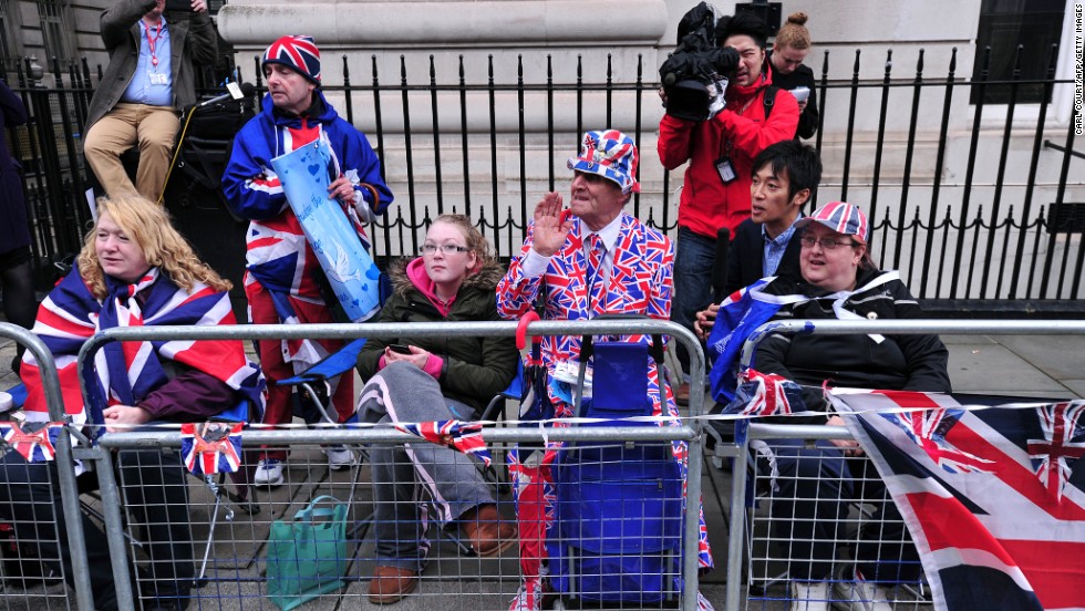 Spectators sport the colors as they wait for the royal family to arrive.
