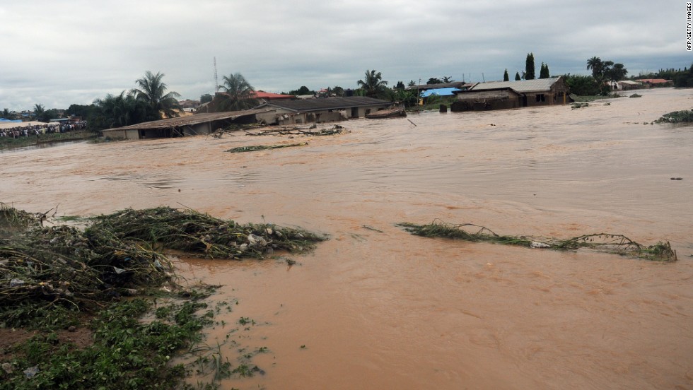 Floodwaters course through Odo Ona in Nigeria&#39;s Oyo State in 2011. At least 102 people were killed when a dam burst during torrential rain.