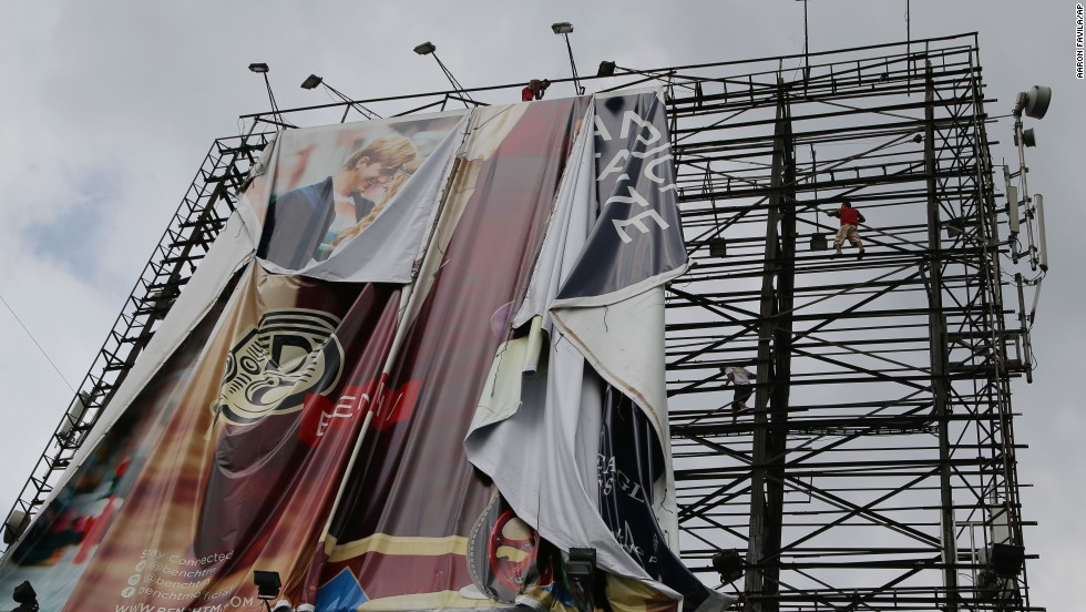 Workers bring down a billboard in Makati, Philippines, on November 7 before Haiyan makes landfall.