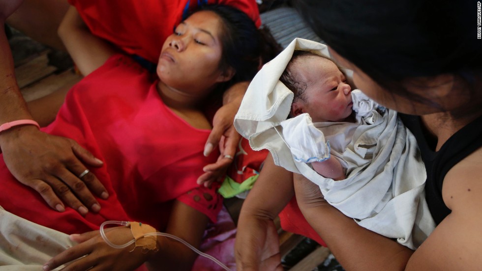 Emily Ortega rests on November 11 after giving birth to Bea Joy at an improvised clinic at the Tacloban airport.
