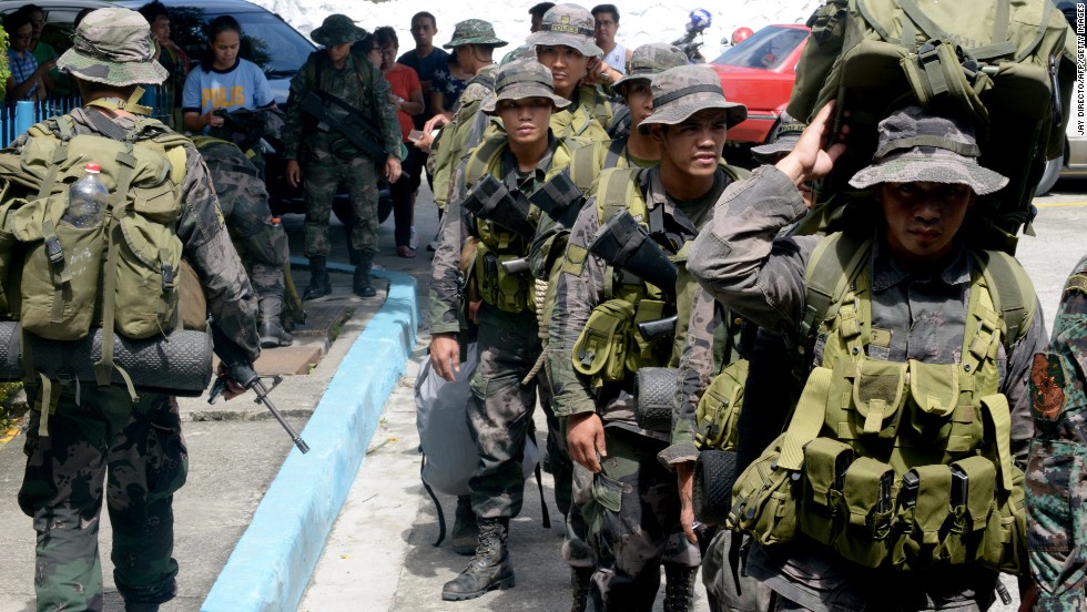 Philippine police commandos prepare to board a military plane in Manila on Sunday, November 10.