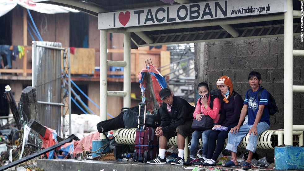People wait at a bus stop November 12 in Tacloban.
