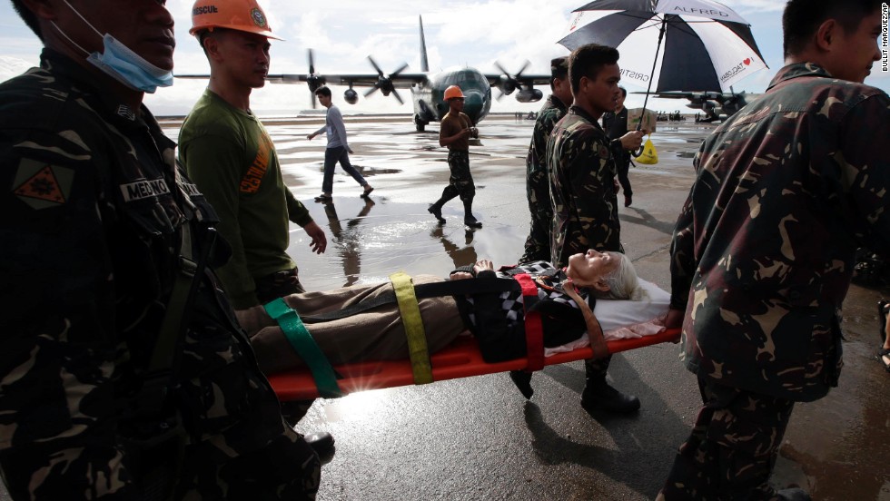 An injured survivor gets carried on a stretcher before being airlifted from Tacloban&#39;s airport November 13. 