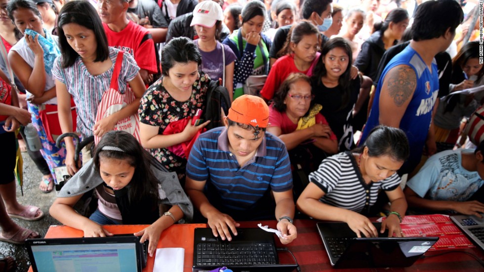 Evacuees send e-mails to their family members and relatives November 12 at a free Internet cafe in Tacloban set up by the Philippine government.