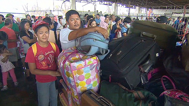 Philippines survivors crowd airport