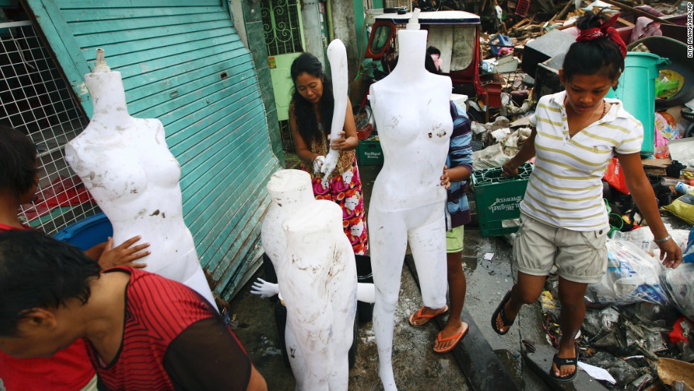 Survivors clean mannequins found among the debris in Tacloban on November 17.