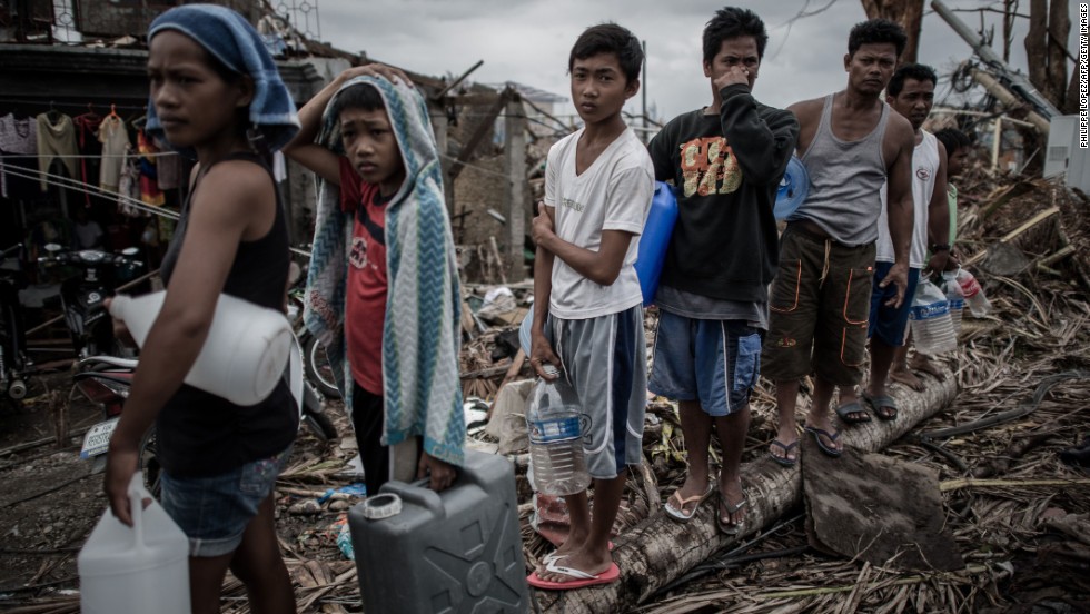 People wait in line for drinking water November 17 in Palo, Philippines.