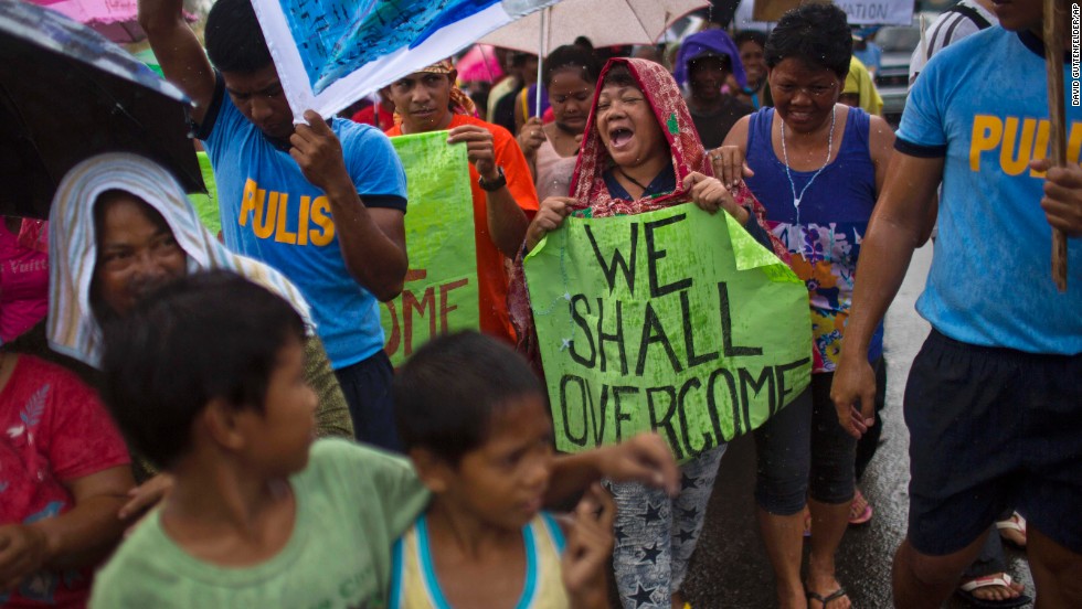 People in Tacloban march in the rain November 19 during a procession calling for courage and resilience among survivors.