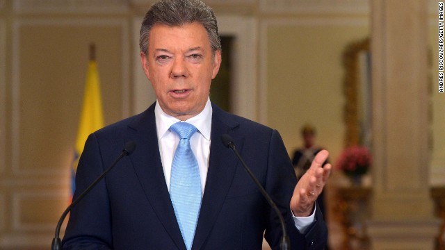 Handout picture released by the Colombian presidential press service showing Colombian President Juan Manuel Santos speaking at Narino Palace in Bogota on November 20, 2013. Santos announced that he will seek re-election next year. "When you see the light at the end of the tunnel, you do not turn around and run the other way, " the president said, referring to a peace process with Revolutionary Armed Forces of Colombia (FARC) guerrillas that is making strides but is not yet a done deal. 