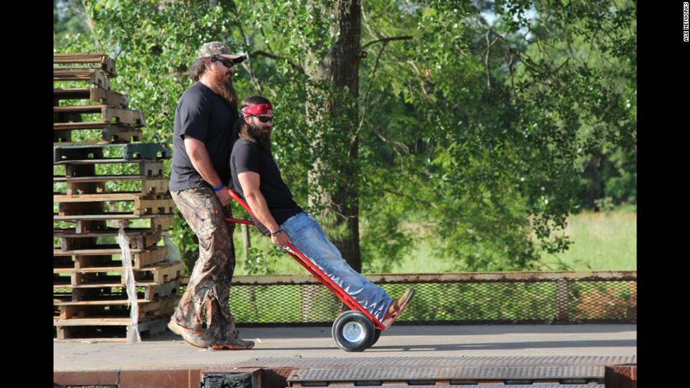Jep Robertson, one of Willie&#39;s brothers and Phil&#39;s sons, is pushed along by Duck Commander employee Justin Martin.