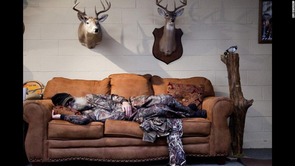 Si takes one of his daily naps, surrounded by some Robertson family trophies.