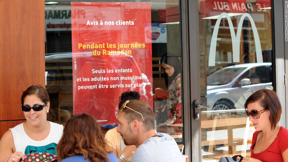 Non-Muslims eat lunch on the terrace of a McDonald's in Rabat, Morocco. Muslim adults are forbidden from being served at the restaurant during the day during fasting for the holy month of Ramadan.