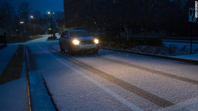 A motorist drives on a snow-and-ice-covered street in Johns Creek, Georgia, on February 12.
