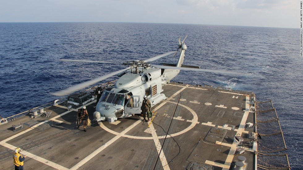 A U.S. Navy Seahawk helicopter lands aboard the USS Pinckney to change crews on March 9, 2014, before returning to search for the missing plane in the Gulf of Thailand.
