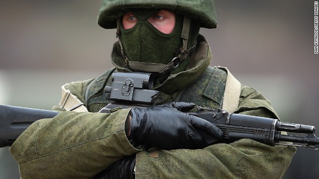 Armed men believed to be Russian military patrol outside a Ukrainian military base on March 12, 2014 in Simferopol, Ukraine.