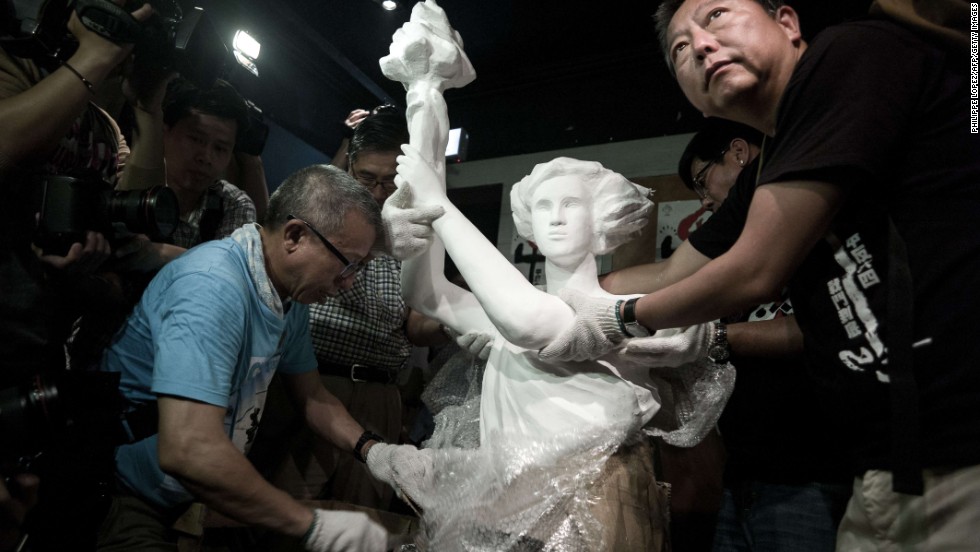 Today, Hong Kong is the only Chinese territory where commemoration of the June 4 crackdown is allowed. Here, pro-democracy legislator Lee Cheuk-yan (left) unwraps a replica of the Goddess of Democracy at Hong Kong&#39;s June 4 Museum that opened on April 24, 2014.