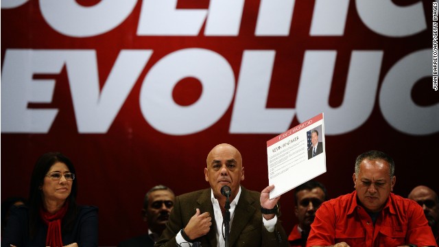 The mayor of the Libertador municipality Jorge Rodriguez (C) shows documents next to the President of National Emsembly Diosdado Cabello (R) and firts lady Cilia Flores during a press conference in Caracas on May 28, 2014. The leadership of Chavez Wednesday accused a handful of opposition politicians, including Congresswoman destitute Maria Corina Machado and the US ambassador in Colombia, Kevin Whitaker, of plotting a coup and assassination against the president Nicolas Maduro.