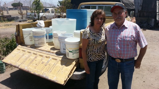 Simona and Adolfo Magana have no running water; they fill these buckets from a neighbor&#39;s tap.