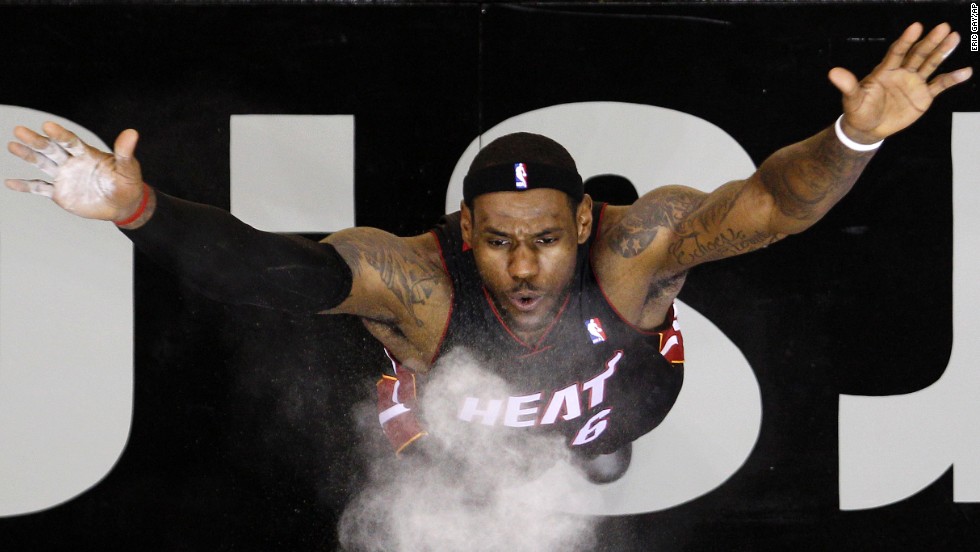 James performs his famous pregame ritual -- throwing crushed chalk into the air -- before a Heat preseason game against the San Antonio Spurs in October 2010. 