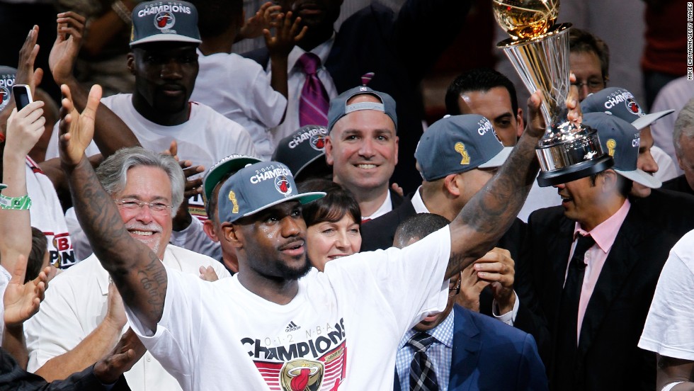 James celebrates with the NBA Finals Most Valuable Player trophy after the Heat defeated the Oklahoma City Thunder to win the NBA title in June 2012.