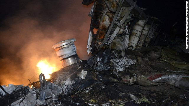 A picture taken on July 17, 2014 shows flames and smoke amongst the wreckages of the malaysian airliner carrying 295 people from Amsterdam to Kuala Lumpur after it crashed, near the town of Shaktarsk, in rebel-held east Ukraine. 