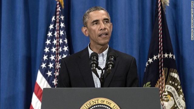 :US President Barack Obama speaks on the situation in Iraq and in Ferguson, Missouri, at Martha&#39;s Vineyard, Massachusetts, on August 14, 2014. Obama called Thursday for &#39;peace and calm&#39; in the Missouri town where the police shooting of an unarmed black youth has sparked angry protests. Obama lamented the &#39;heartbreaking&#39; death of Michael Brown, an 18-year-old killed Saturday in Ferguson but urged both police and protesters to refrain from violence. &#39;Now is the time for peace and calm on the streets of Ferguson,&#39; he told reporters. AFP PHOTO/Nicholas KAMM (Photo credit should read NICHOLAS KAMM/AFP/Getty Image