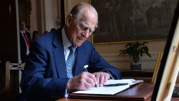 Prince Philip signs the guest book at Hillsborough Castle in Belfast, Northern Ireland, in June 2014.