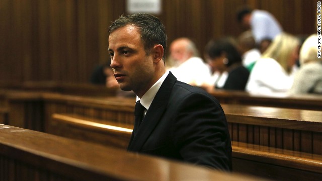 Oscar Pistorius sits in front of family members of the late Reeva Steenkamp on his arrival in court in Pretoria, South Africa, Friday, Sept. 12, 2014. Cleared of murder, Pistorius on Friday awaited a possible conviction for negligent killing as the South African judge presiding over his murder trial resumed her lengthy explanation of her upcoming verdicts in the killing of his girlfriend